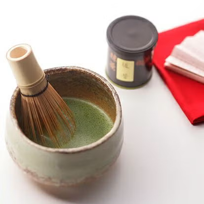 Prepared Japanese matcha in a tea bowl with a bamboo whisk
